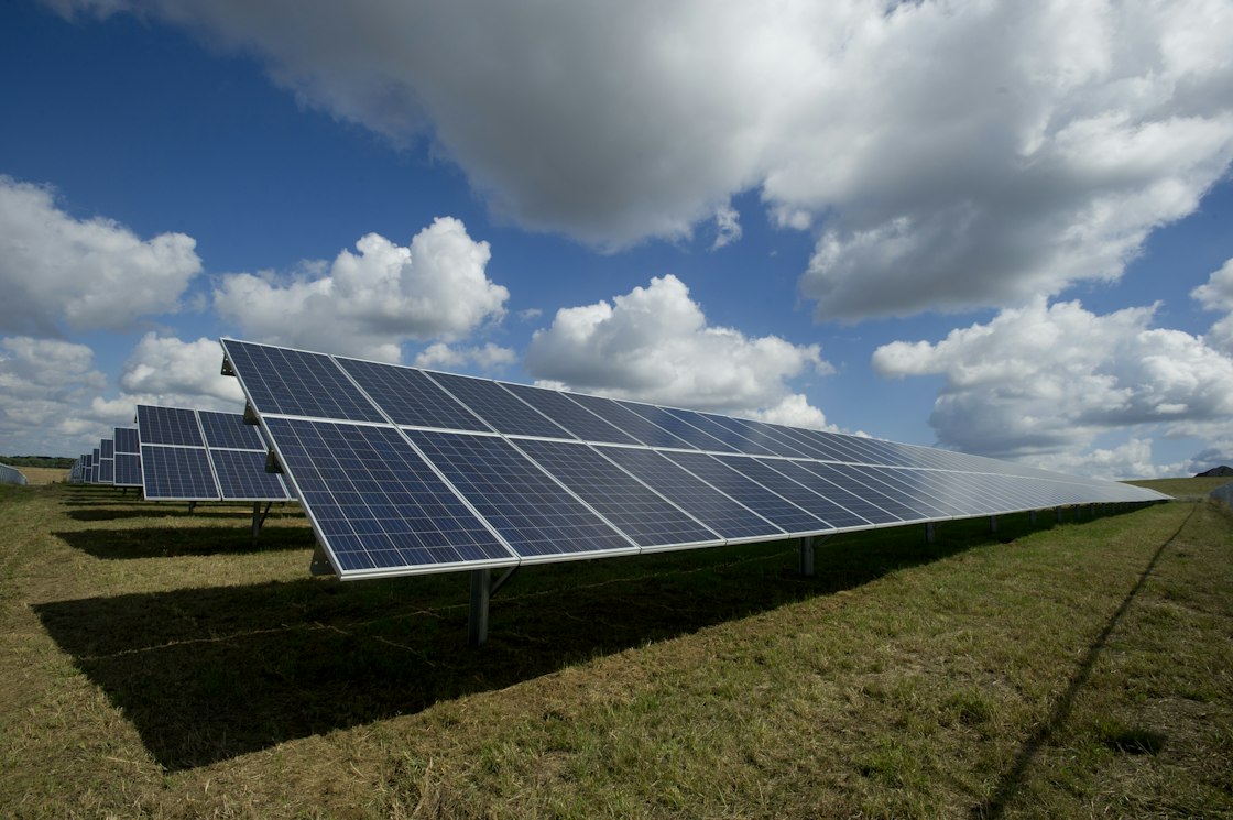 Solar panels installed in an open landscape